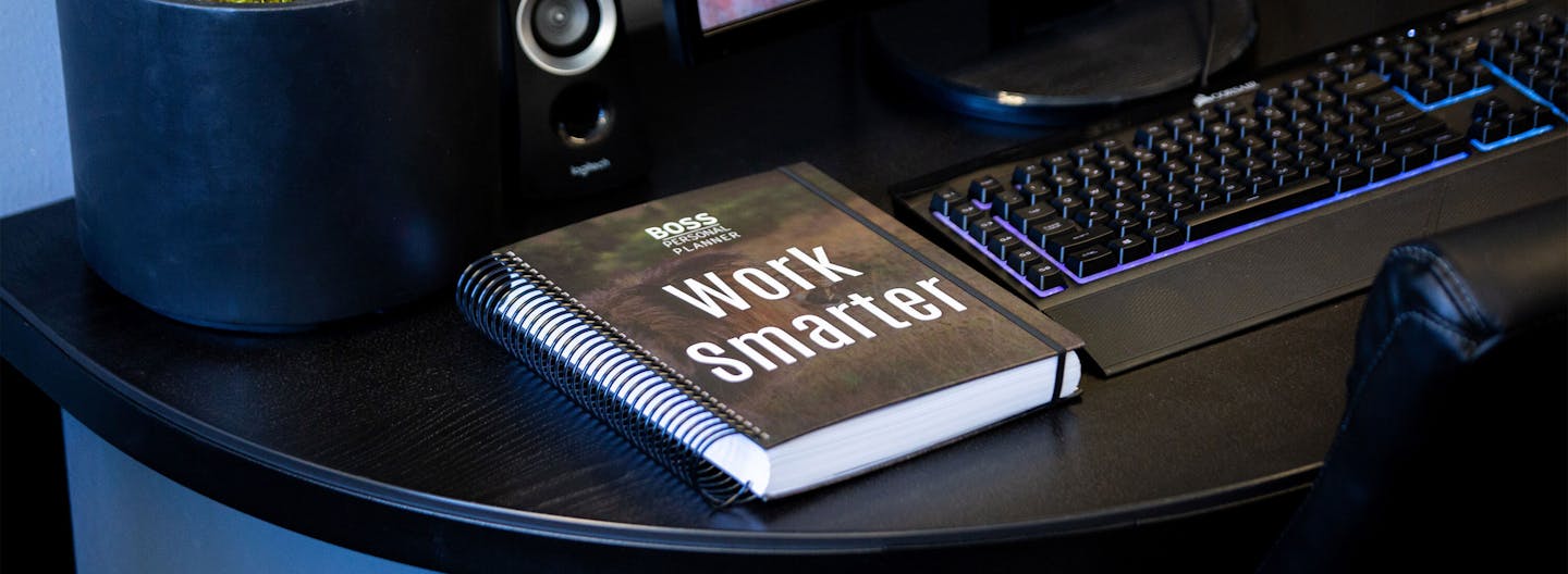 Boss Personal Planner Ultimate Paper planner with lion Work Smarter cover sitting on a desk